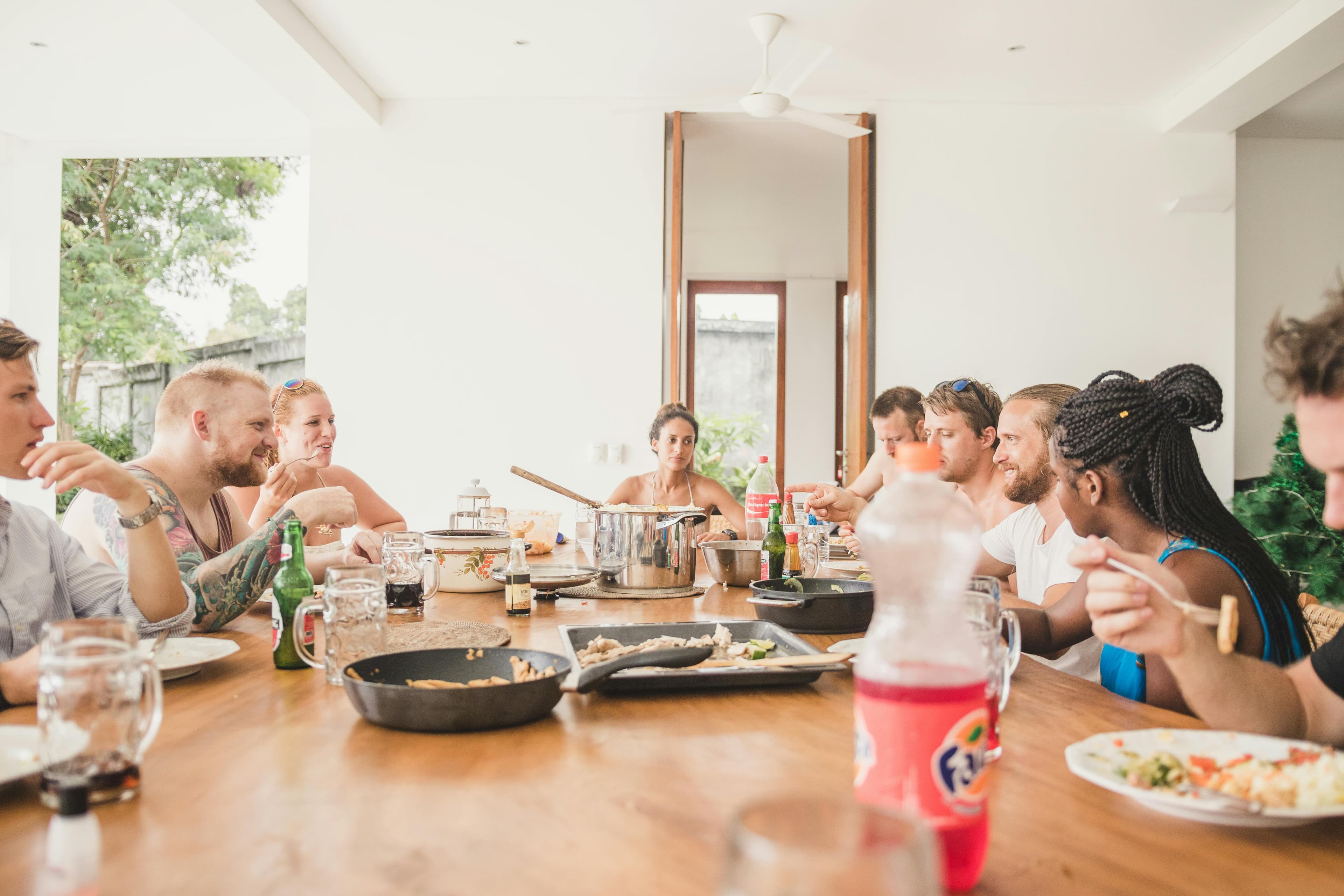 People sharing food around a community table